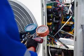 HVAC technician servicing an outdoor air conditioning unit