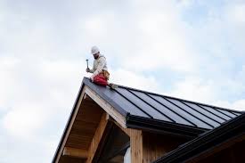 Roofer installing metal roofing on a residential home